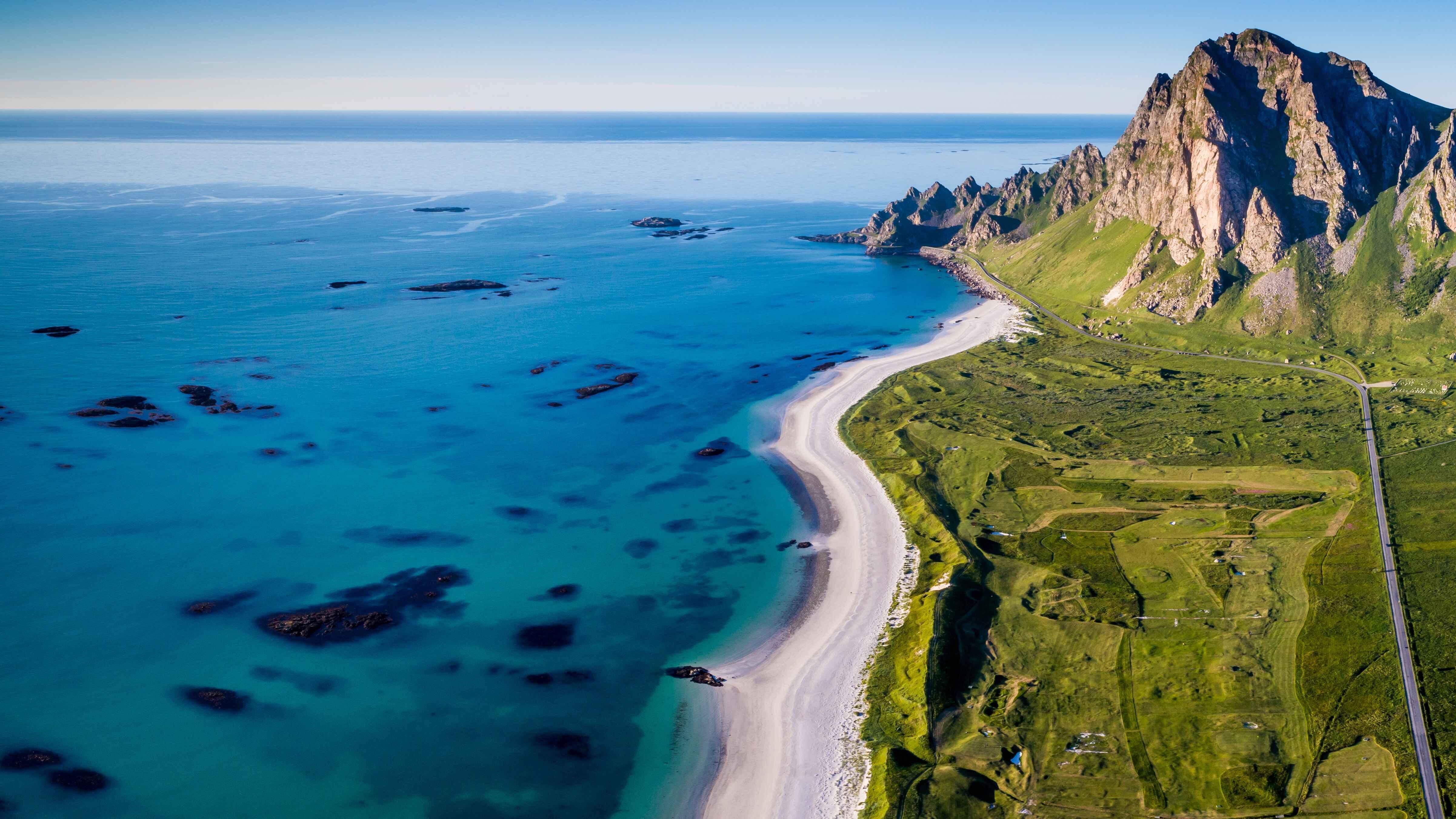 Aerial view of a beach, turquoise sea and mountains, nature backdrop for stamox beetroot powder SEO