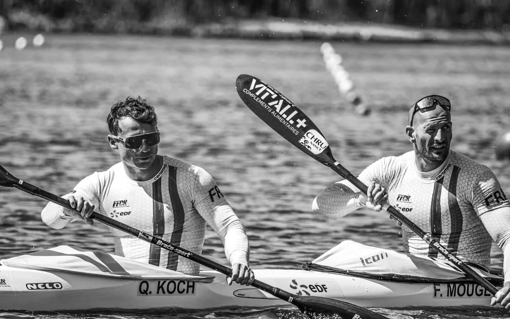 Two rowers in kayaks on a river with paddles, wearing sunglasses and sports attire. Athlete Quilian Koch, a multiple National Champ, and placed 3rd in the World & European Championships, relies on Stamox to elevate his performance on the water.