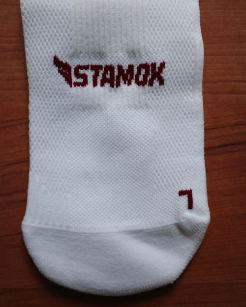 White athletic sock featuring the Stamox beetroot sport nutrition VO2 max logo.