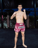 Athlete in boxing stance wearing YOKKAO shorts, fueled by Stamox beetroot powder for endurance and recovery.