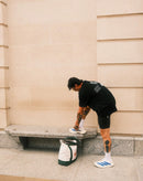 Athlete tying shoes on bench with gym bag, active lifestyle for stamox beetroot powder