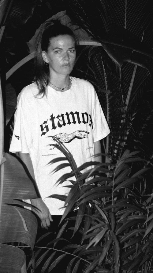 Person in Stamox branded shirt surrounded by plants, Stamox Beetroot Powder promotion