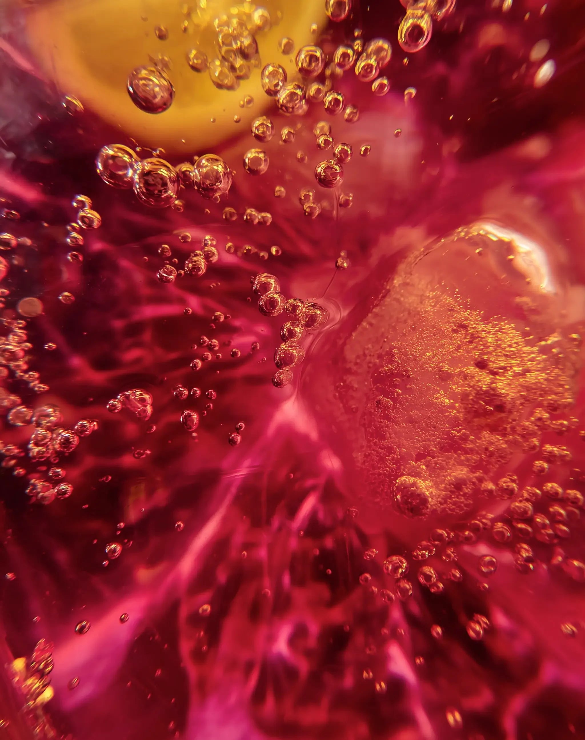 Close up of stamox beetroot powder mixing in water with vibrant red color and bubbles