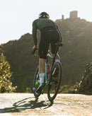 Cyclist riding uphill in sunlight, promoting Stamox Beetroot Powder for endurance