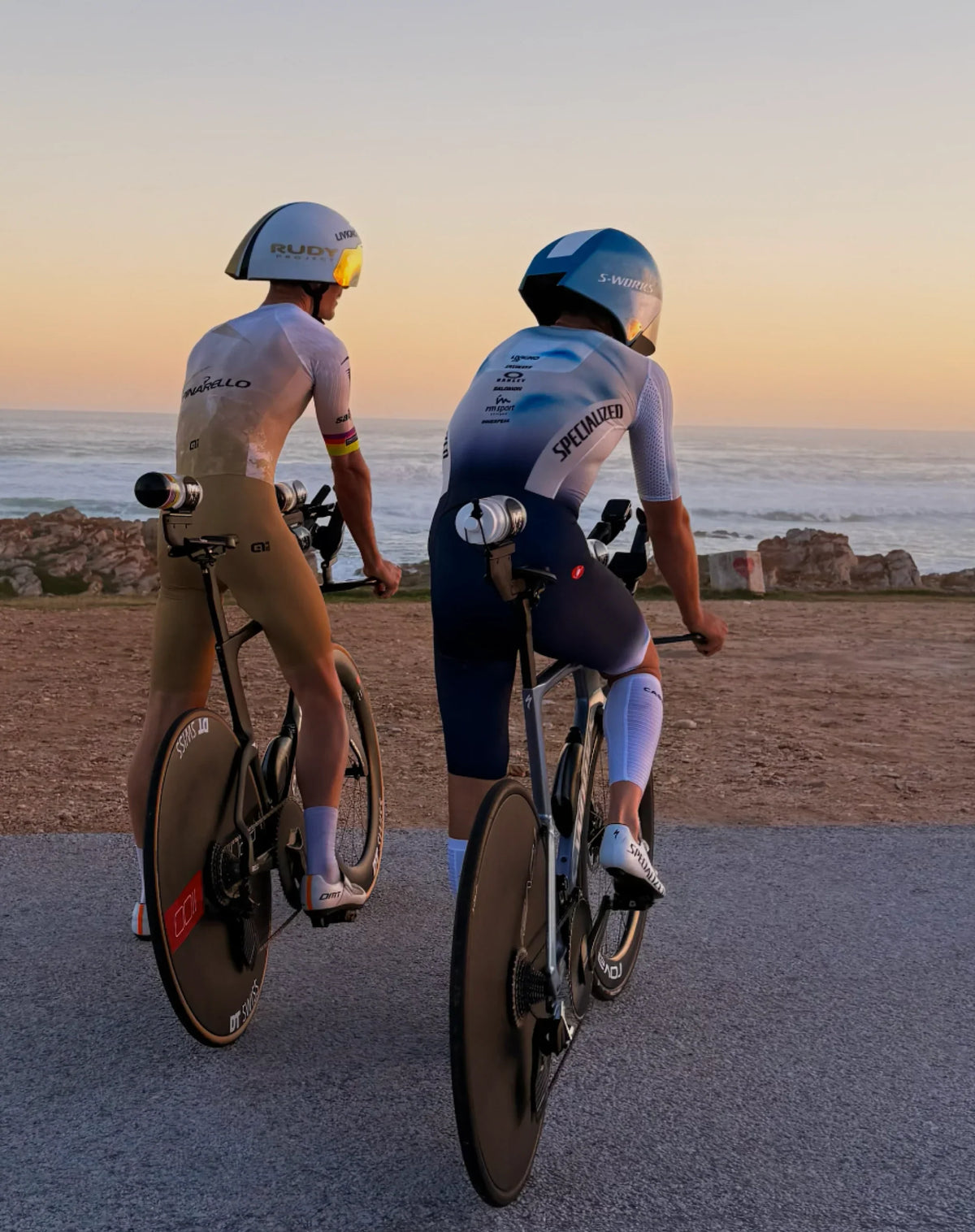 Two cyclists with aero helmets on time trial bikes at sunset, optimizing vo2 max and performance.