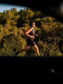 Athlete running outdoors in sunlight, showcasing stamina from Stamox beetroot powder