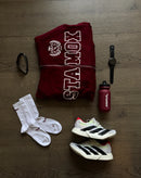 Stamox beetroot powder sports kit with socks, sneakers, bottle, sweatshirt, watch, and glasses