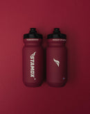 Two red sports bottles with Stamox branding, used for Stamox beetroot powder, on a red background.