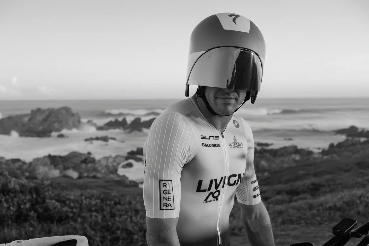 Cyclist in aerodynamic gear by the ocean, stamox beetroot powder for endurance and performance