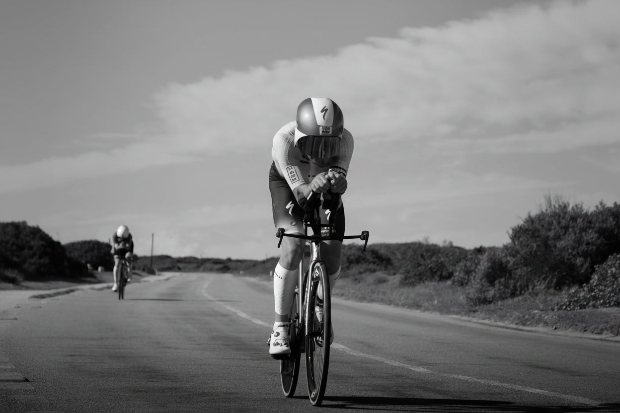 Cyclist racing on road in aero gear, endurance enhanced by Stamox beetroot powder