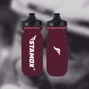 Two maroon water bottles with black lids on a blurred background