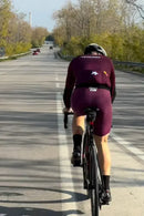 Cyclist in Stamox branded gear riding on road, promoting stamox beetroot powder for endurance