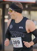 Athlete running in marathon wearing black Stamox Beetroot Powder shirt and race bib 289