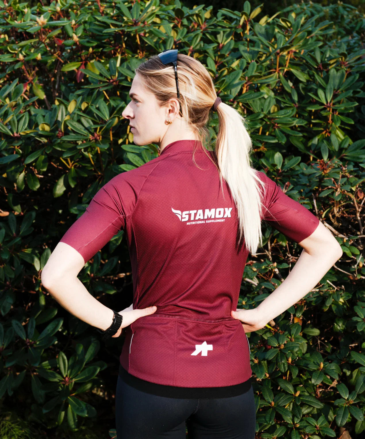 Woman in athletic wear outdoors, promoting stamox beetroot powder for endurance