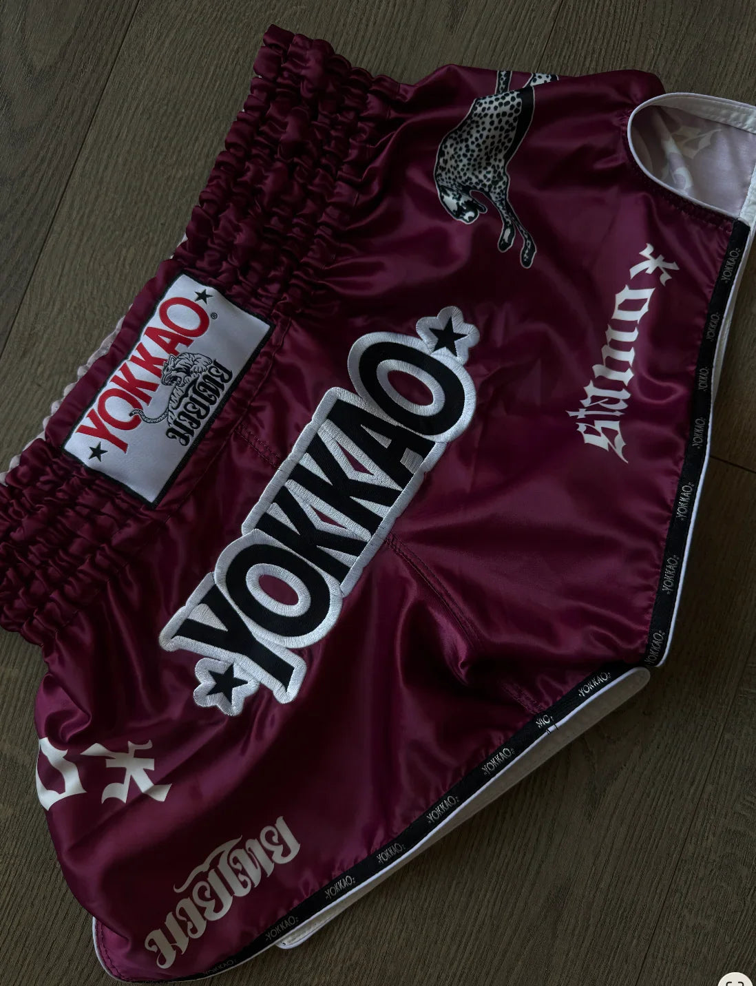 Maroon boxing shorts with white Yokkao logos, ideal for stamox beetroot powder users