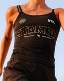 Runner in black top outdoors wearing stamox beetroot powder apparel for endurance