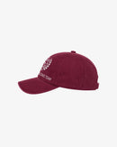 Maroon racing team cap with white laurel emblem, paired with Stamox beetroot powder for athletic performance.