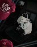 Stamox beetroot powder jars in car with racing gear, cap, and tote bag for athletic recovery and endurance