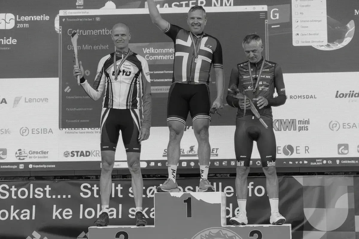 Three male cyclists on a winners podium celebrating a race, stamox beetroot powder