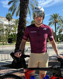Cyclist in Stamox jersey posing with bike, promoting Stamox beetroot powder outdoors.