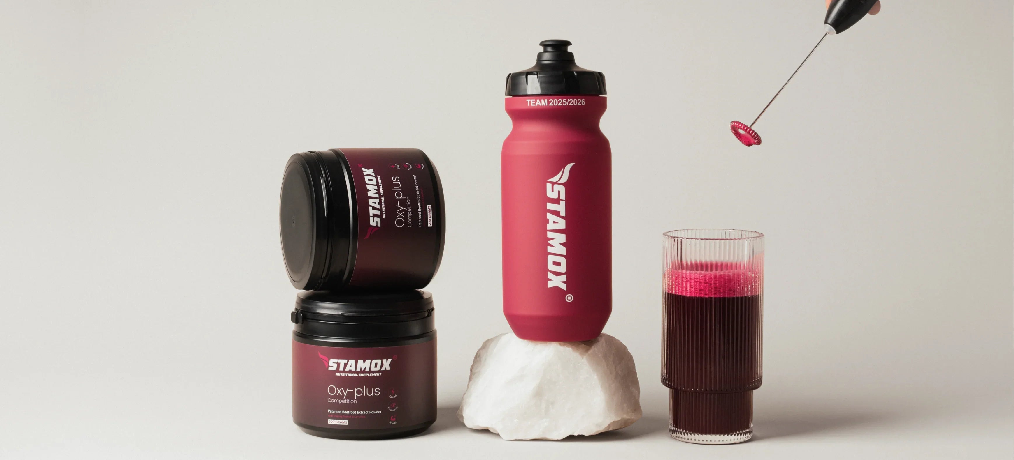 Stamox beetroot powder jars, bottle, and prepared beetroot drink with a frother on a light background.