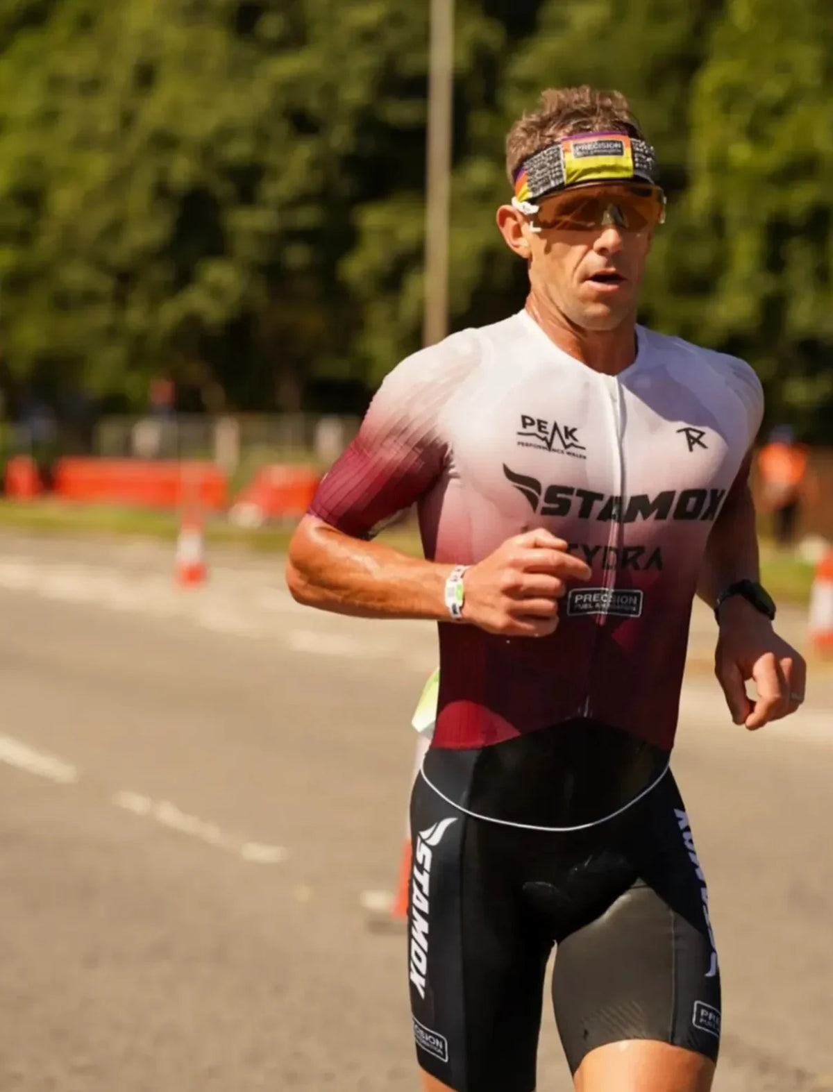 Athlete running in performance gear, showcasing endurance and fitness during a race.