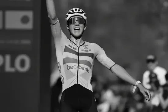 Cyclist raising arm in race finish, showcasing stamox beetroot powder athletic endurance benefits