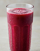 Stamox beetroot powder drink in a chilled glass, vibrant red with condensation, for endurance and recovery.
