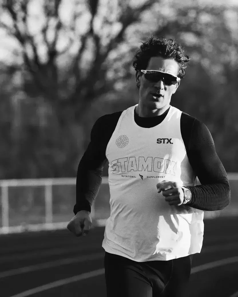 Athlete running outdoors wearing STAMOX shirt, promoting stamox beetroot powder for endurance