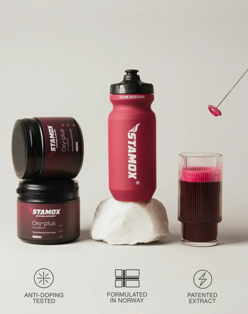 Stamox beetroot powder containers, water bottle, and glass of beetroot drink on cream background