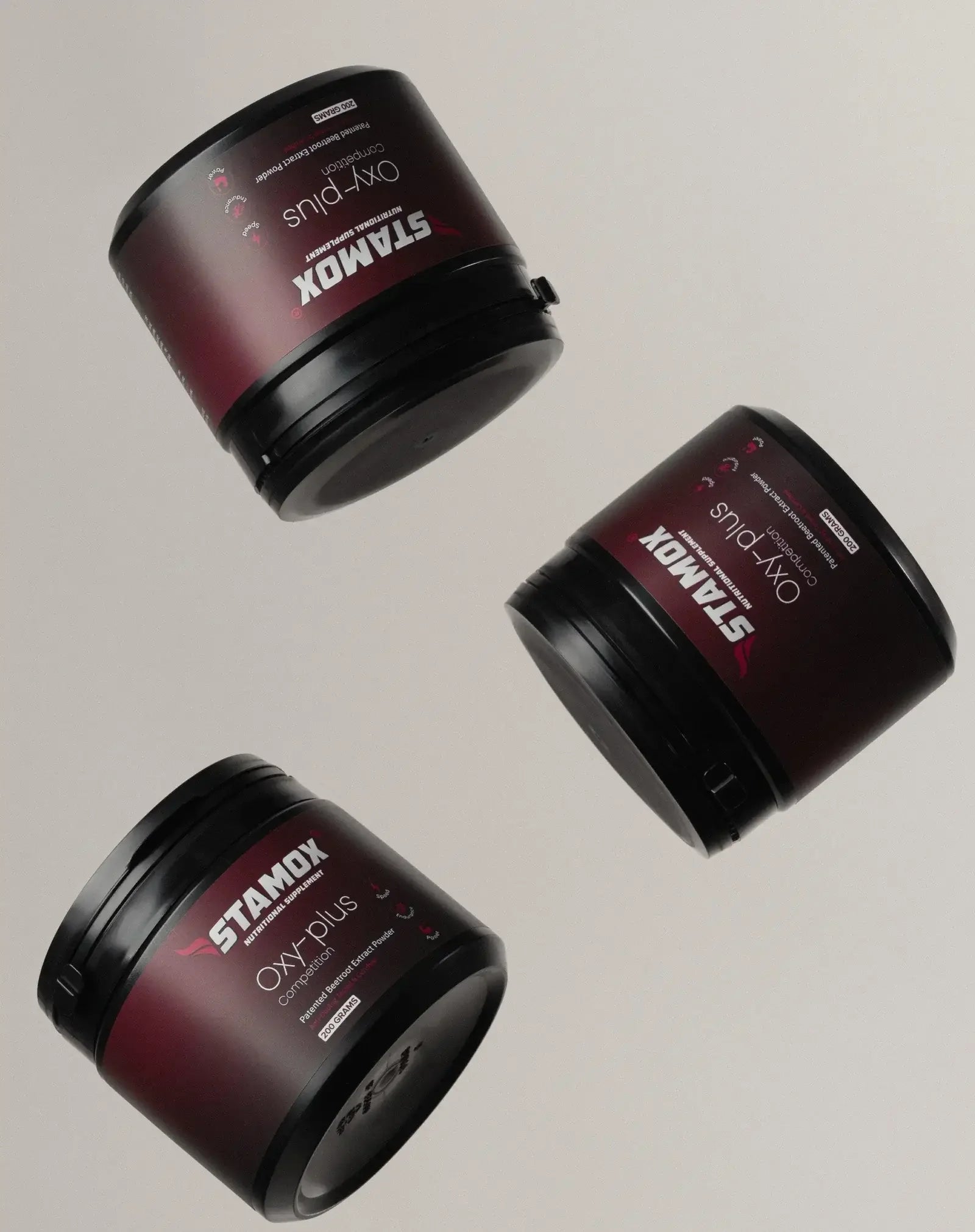 Three tubs of Stamox beetroot powder dietary supplement on a neutral background