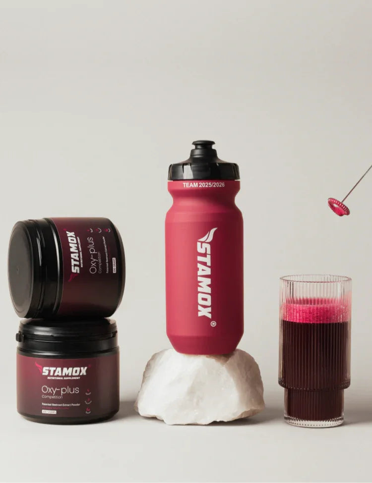 Stamox beetroot powder containers, sports bottle, and glass with beetroot drink on neutral background