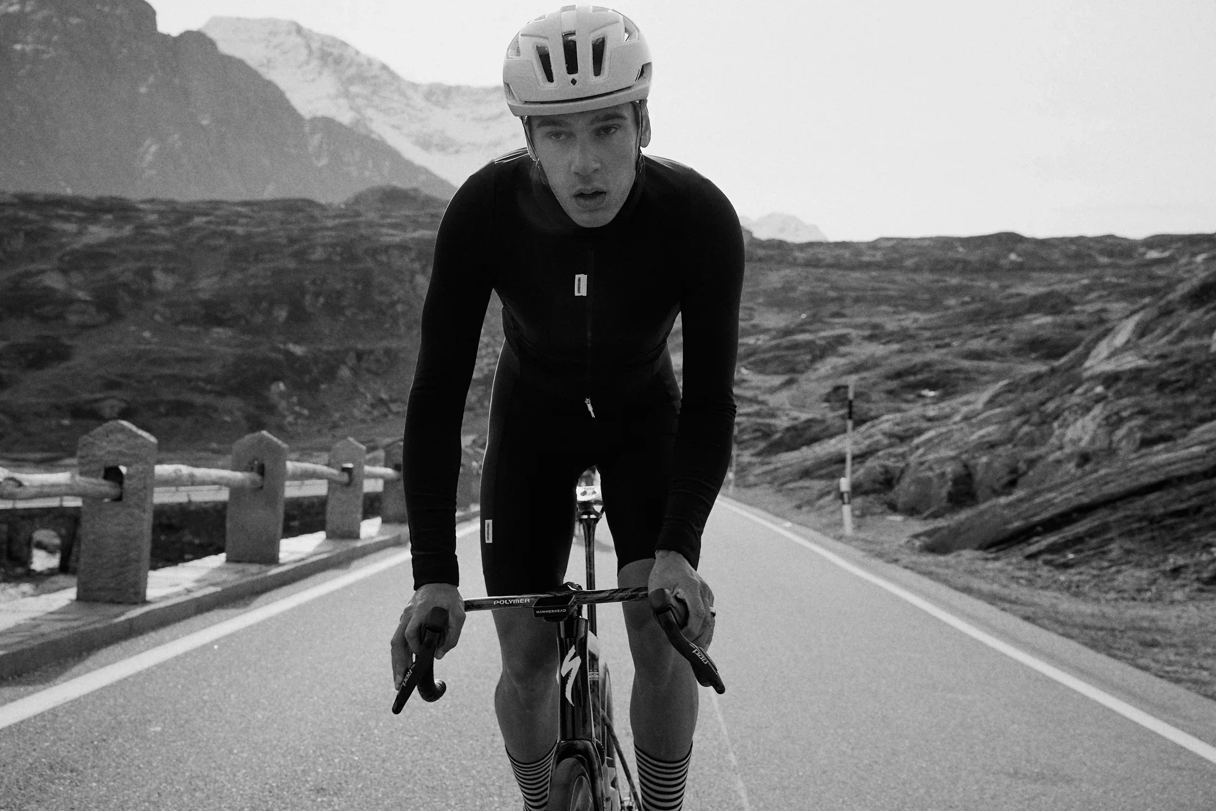 Cyclist training on mountain road, promoting Stamox beetroot powder for endurance