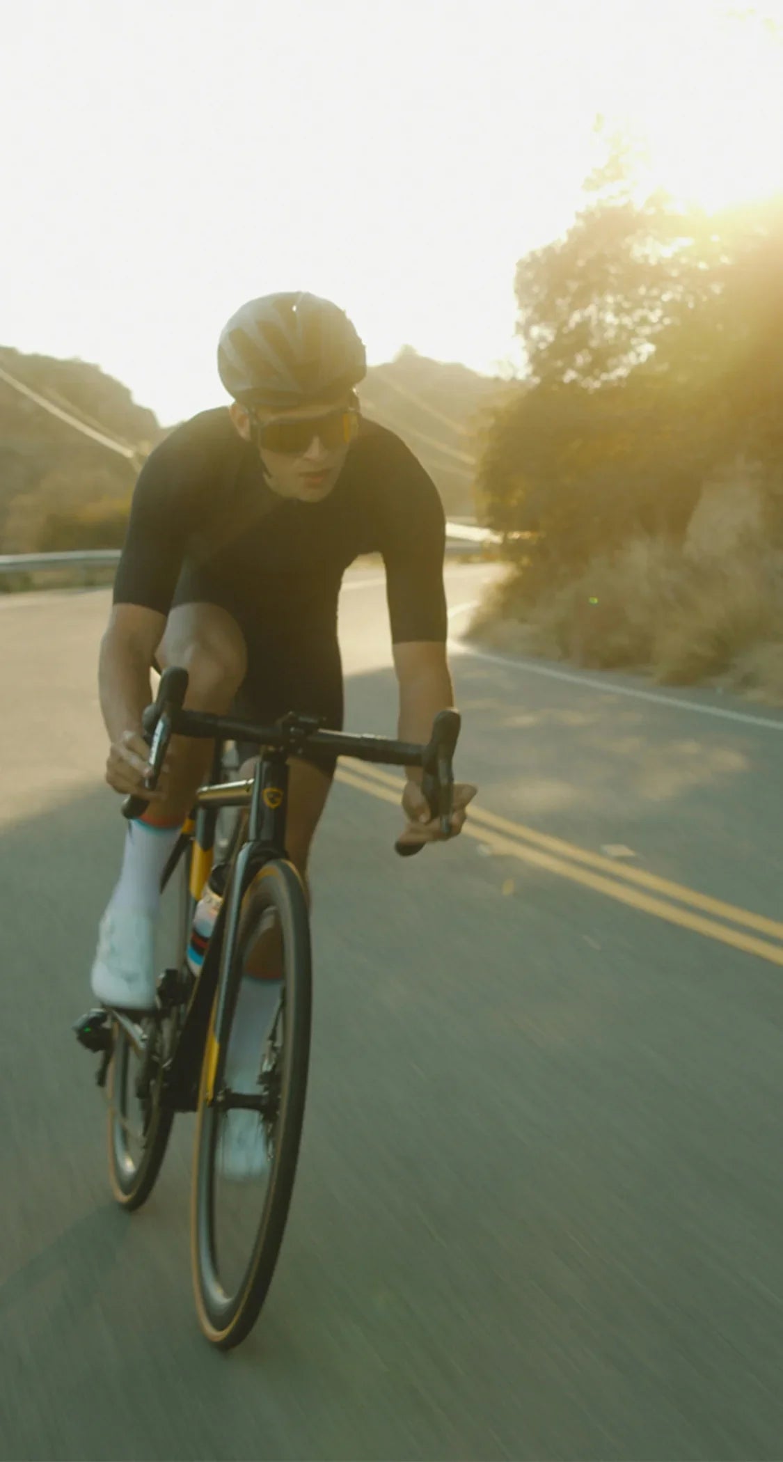 Cyclist riding on a road with a scenic background Stamox Beetroot Powder