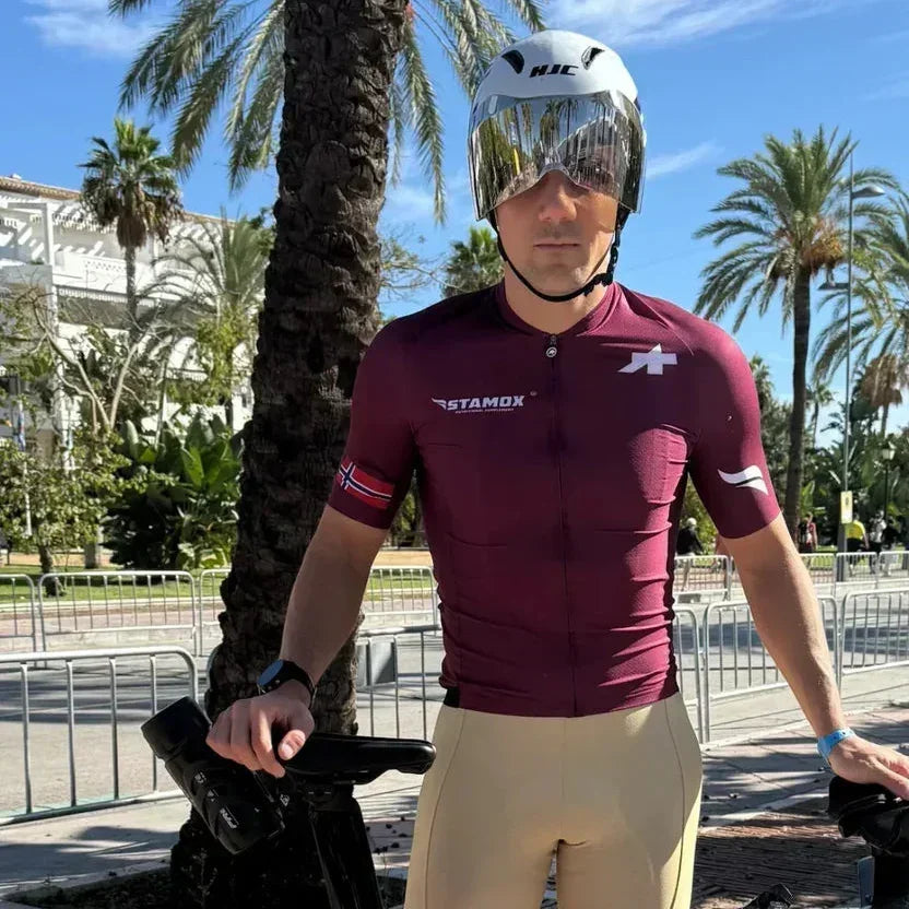Cyclist in Stamox jersey and helmet outdoors, stamox beetroot powder for cycling endurance