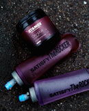 Stamox beetroot powder jar with purple hydration bottles on gravel, ideal for endurance and recovery