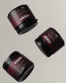 Three stamox beetroot powder containers with maroon labels on a light background