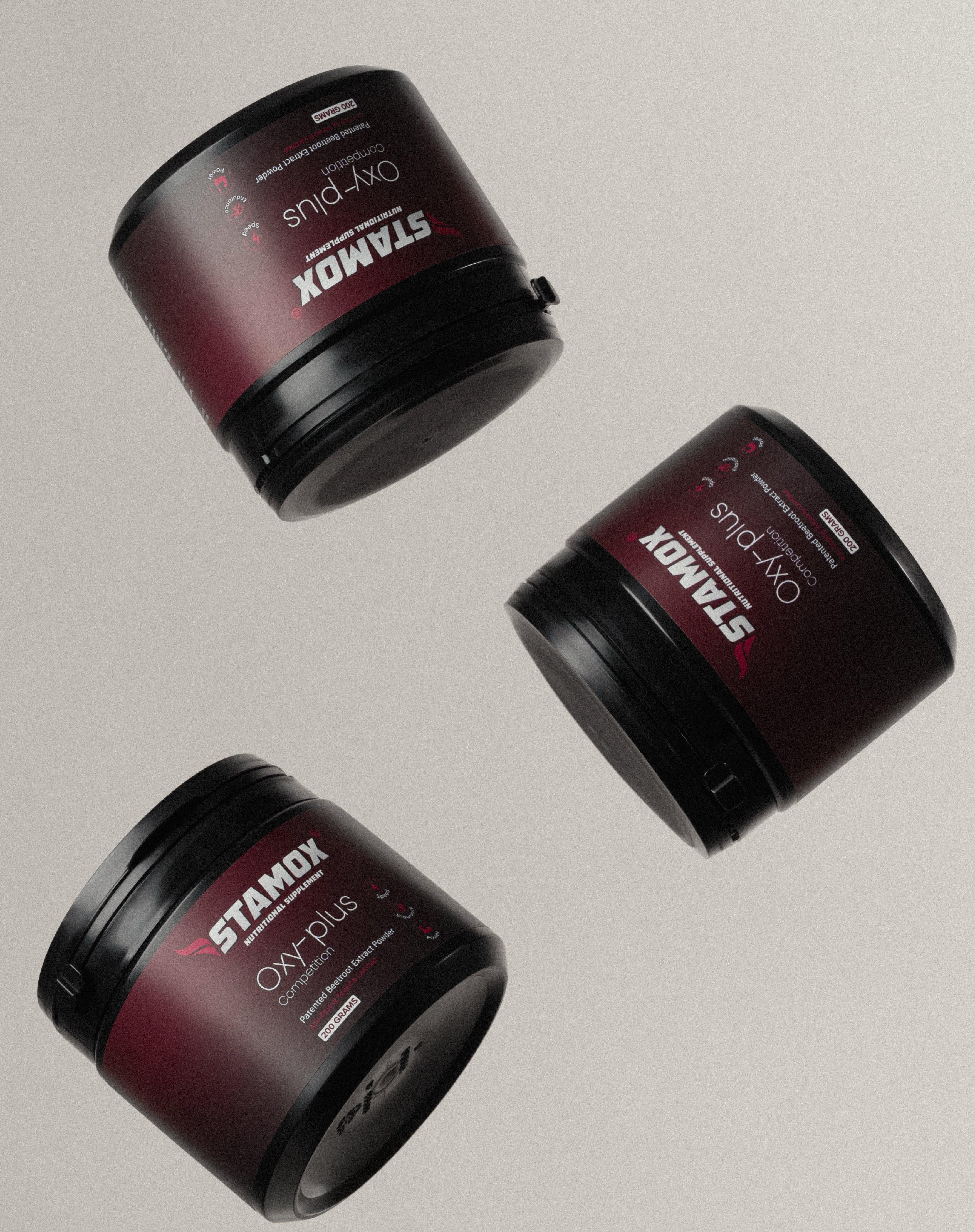 Three stamox beetroot powder containers with maroon labels on a light background