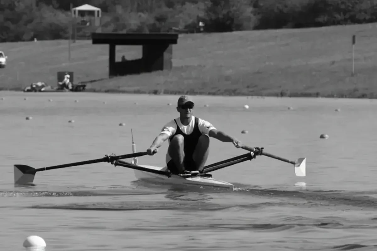Athlete rowing on water, promoting stamina and power with stamox beetroot powder
