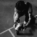 Tattooed athlete with stamox beetroot sport nutrition for vo2 max on a track.