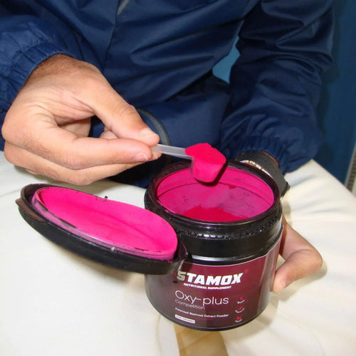 Person scooping Stamox beetroot sport nutrition powder to improve VO2 max