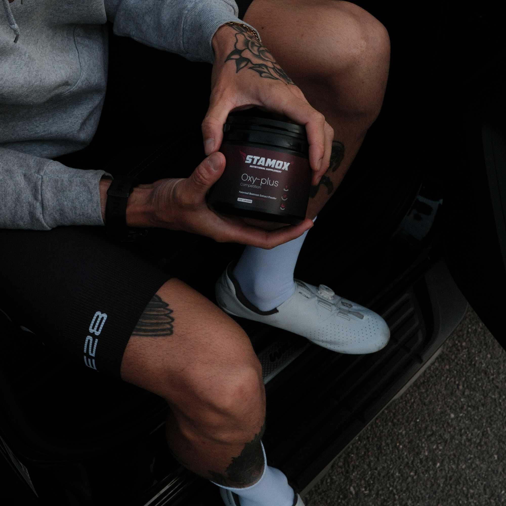 Person holding Stamox beetroot sport nutrition for vo2 max in a vehicle
