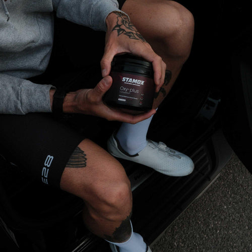Person holding Stamox beetroot sport nutrition for vo2 max in a vehicle