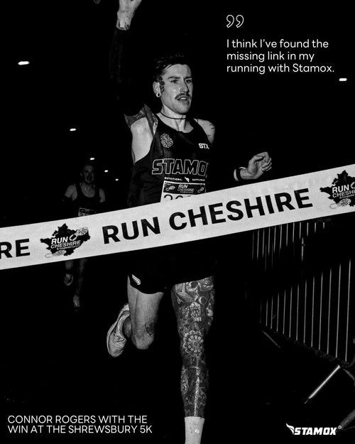 Runner crossing finish line at 5K race, celebrating Stamox beetroot powder for endurance.